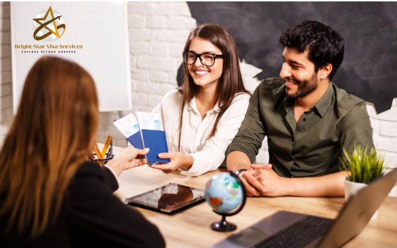 Couple meeting a visa consultant and holding passports during a travel visa appointment